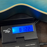 Used Epiphone Les Paul IV Blue on scale displaying weight.