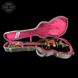 Gretsch guitar in a pink case with 'Tone Shop' logo in the corner.