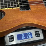 Used Ibanez Mike Mushok MMM1 Baritone on scale displaying weight.