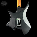 Black electric guitar with a visible brand logo on a black background