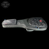 Guitar case with quilted design on a black background, featuring the Tone Shop logo.