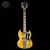 A classic electric guitar with a natural wood finish, shown from the front against a solid black background. The brand 'Tone Shop' is visible as a watermark in the top-left corner.