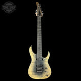 Electric guitar with a worn finish on a black background, featuring the Tone Shop logo.