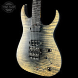 Electric guitar with a wavy wood finish on a black background, featuring the Tone Shop logo.