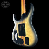 Electric guitar with a sunburst finish on a black background, featuring the Tone Shop logo.