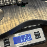 Digital scale displaying weight of a guitar on a wooden surface