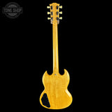 A classic electric guitar shown from the back, featuring a glossy natural maple wood finish with a distinctive double-cutaway body shape and a black pickguard, set against a solid black background.