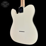 The back of a white electric guitar with a maple neck, shown against a solid black background. A Tone Shop watermark is visible in the top-left corner.