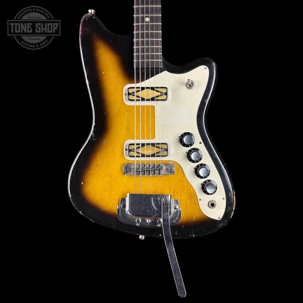 Vintage electric guitar with a sunburst finish on a black background, featuring the Tone Shop logo.