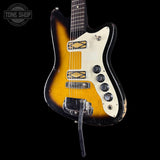 Vintage electric guitar with a sunburst finish on a black background, featuring the Tone Shop logo.