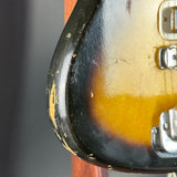 Close-up of a guitar case with a dark brown and black finish.