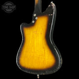 Back of a guitar with a sunburst finish on a black background, featuring 'Tone Shop' logo.