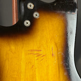Close-up of a guitar's wood finish with screws