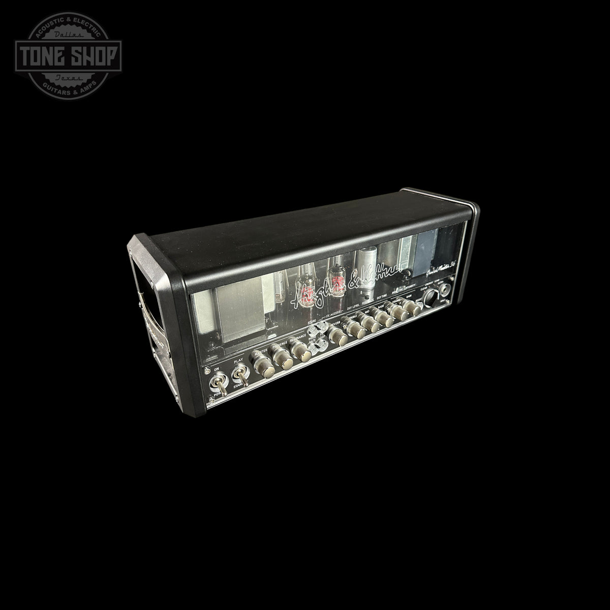 Guitar amplifier head with control knobs and display on a black background, featuring 'Tone Shop' logo.