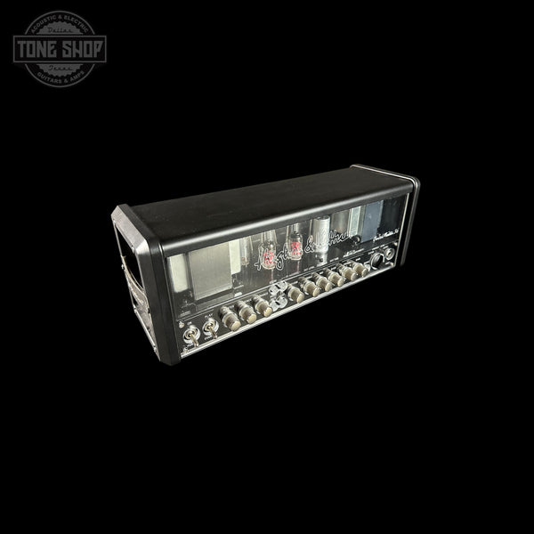 Guitar amplifier head with control knobs and display on a black background, featuring 'Tone Shop' logo.