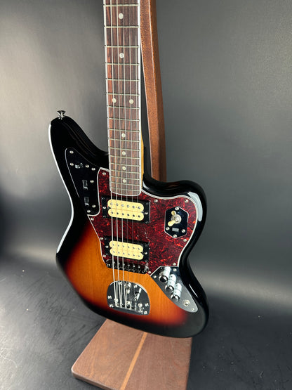 Electric guitar with a sunburst finish on a dark background