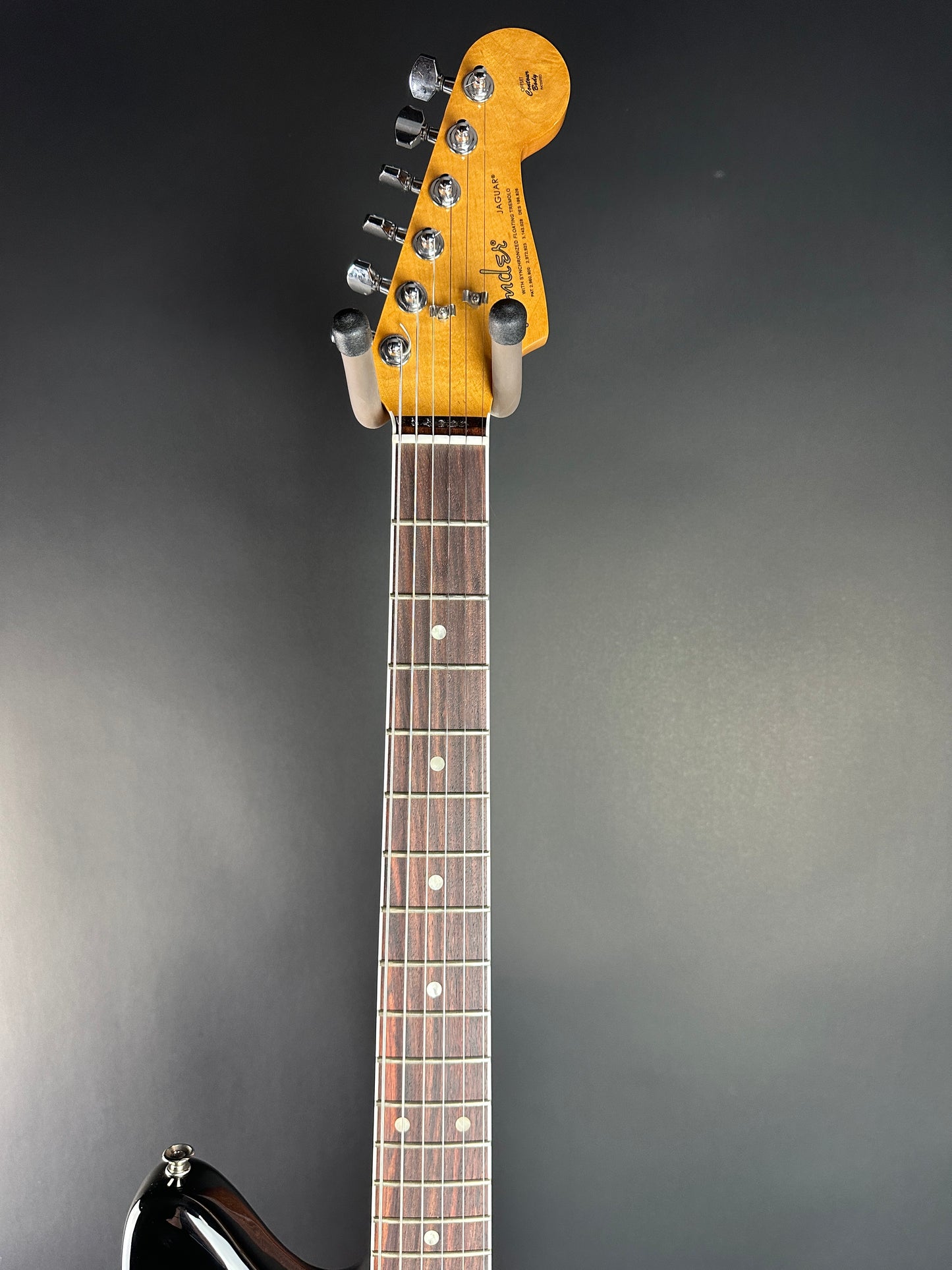Guitar neck and headstock on a dark background