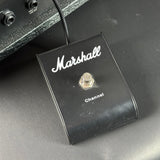 Marshall guitar pedal switch on a dark surface