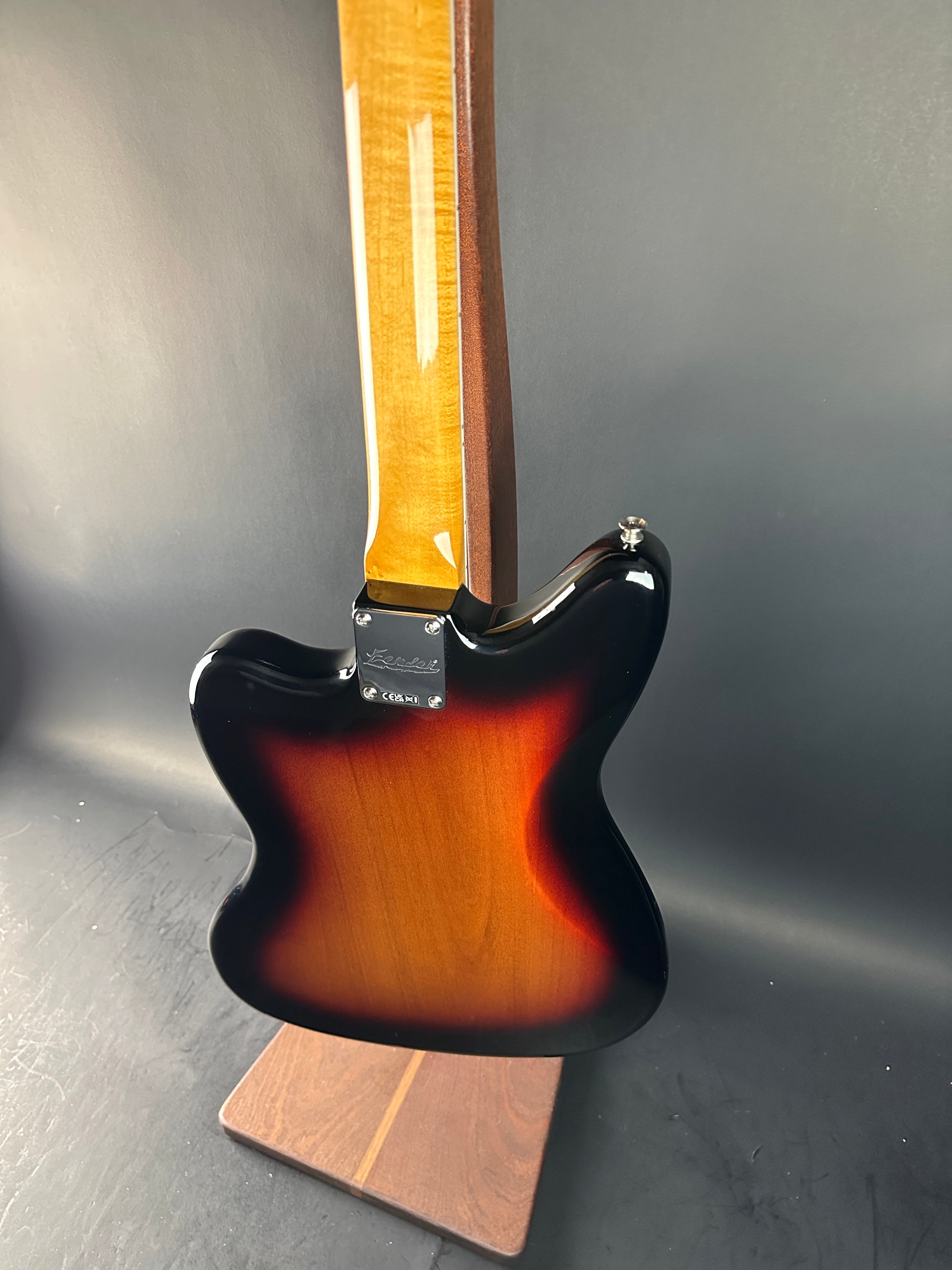 Close-up of a guitar body with a sunburst finish on a gray background