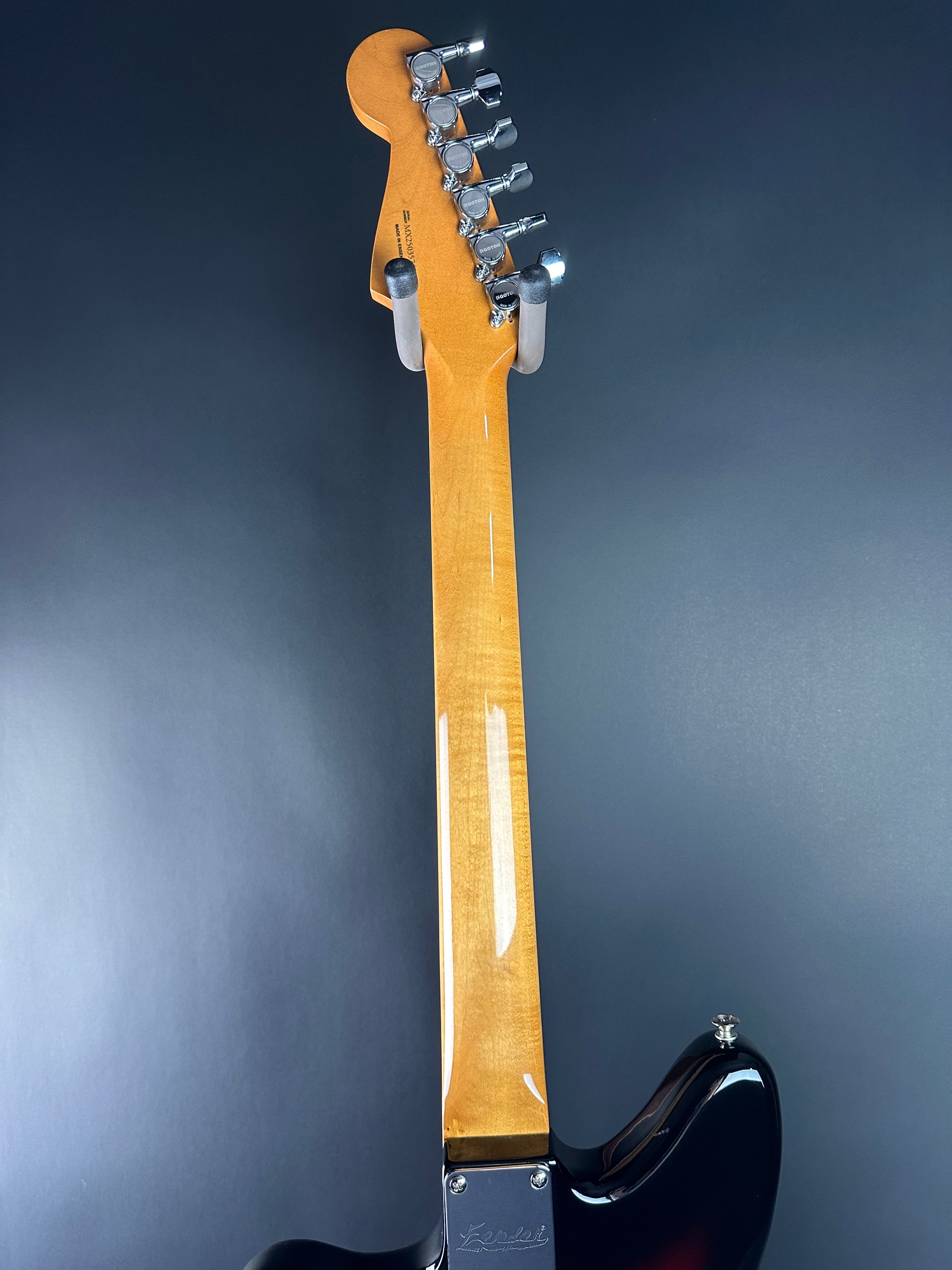Close-up of a guitar neck with a dark background