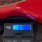 Fender Custom Shop TSG Exclusive 1962 Jazzmaster Chambered Seminole Red on scale displaying weight.