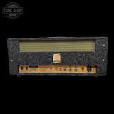 Vintage-style guitar amplifier head with decorative front panel on a black background, featuring the Tone Shop logo.