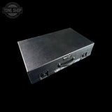 Black guitar case with a visible brand logo on a black background