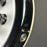 Close-up of a mechanical component with a gear and black casing on a gray background
