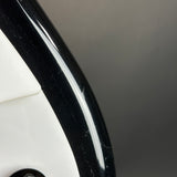Close-up of a black car rim with a blurred background