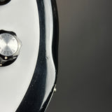 Close-up of a watch with a brand logo on a dark background