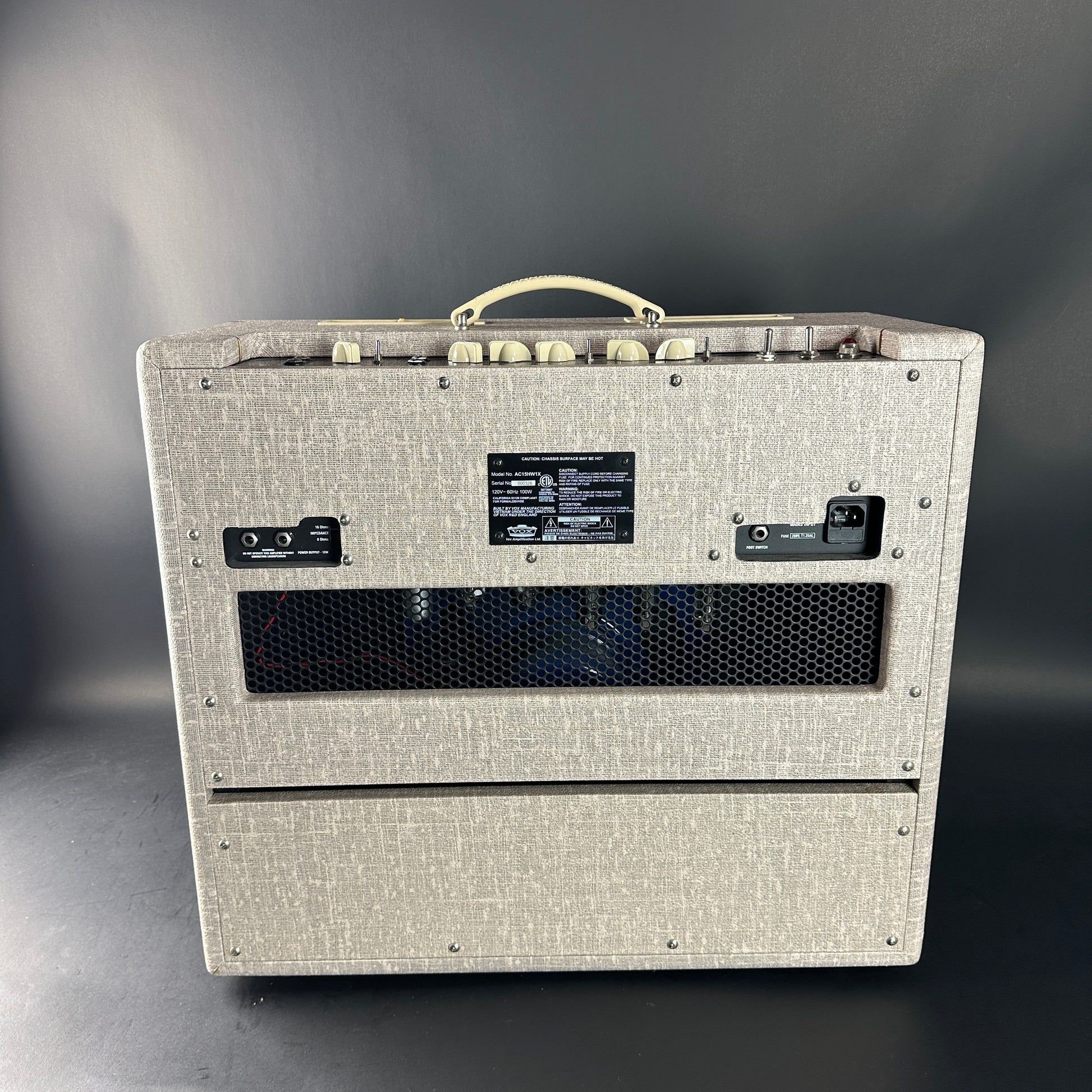 Guitar amplifier with textured gray finish on a dark background