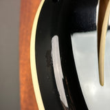 Close-up of a guitar's soundhole with a wooden body.