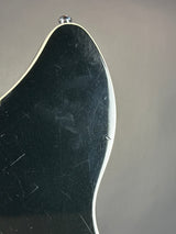 Close-up of a metallic object with a reflective surface on a gray background