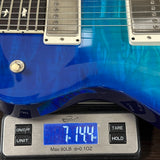 Blue electric guitar on a digital scale displaying weight.