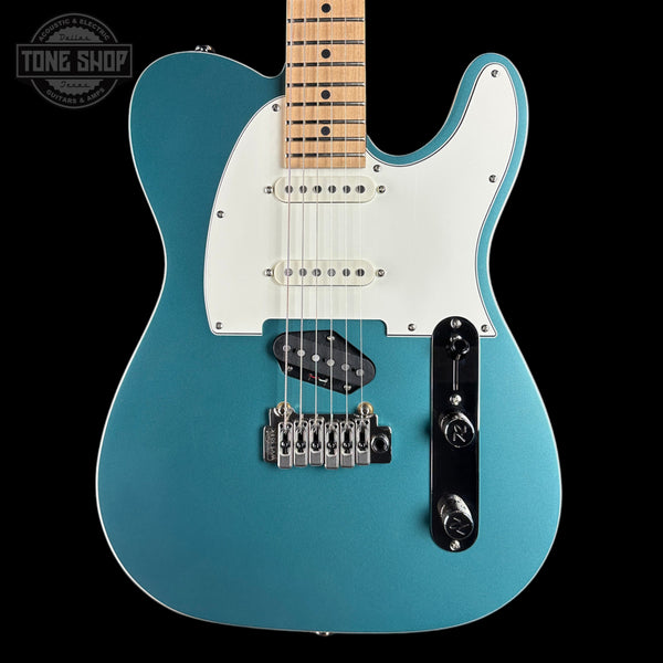 Blue electric guitar with a white pickguard on a black background, featuring 'Tone Shop' branding.