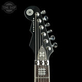 Guitar headstock with brand logo on a black background