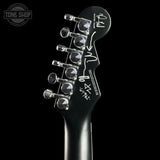 Guitar headstock with brand logo on a black background