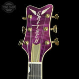 Purple Gretsch guitar headstock on a black background