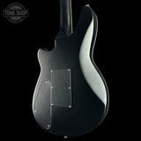 Black electric guitar on a black background with 'Tone Shop' logo.