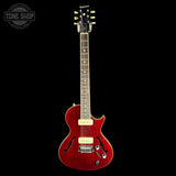 Red electric guitar on a black background with 'Tone Shop' logo.