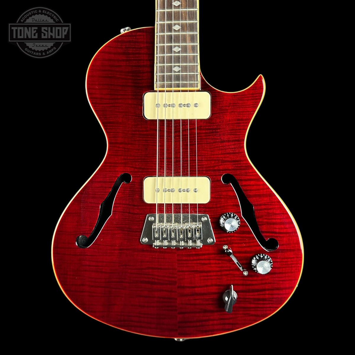 Red electric guitar with a black background