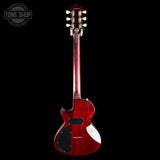 Red electric guitar on a black background with 'Tone Shop' logo.
