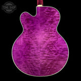 Purple electric guitar with a visible brand logo in the corner