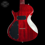 Red electric guitar with a black pickguard on a black background, featuring 'Tone Shop' branding.