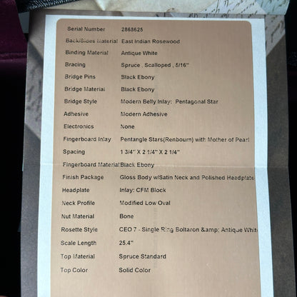 Technical specifications sheet for a guitar on a cardboard background