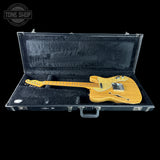 Yellow electric guitar in a black case with 'Tone Shop' logo.
