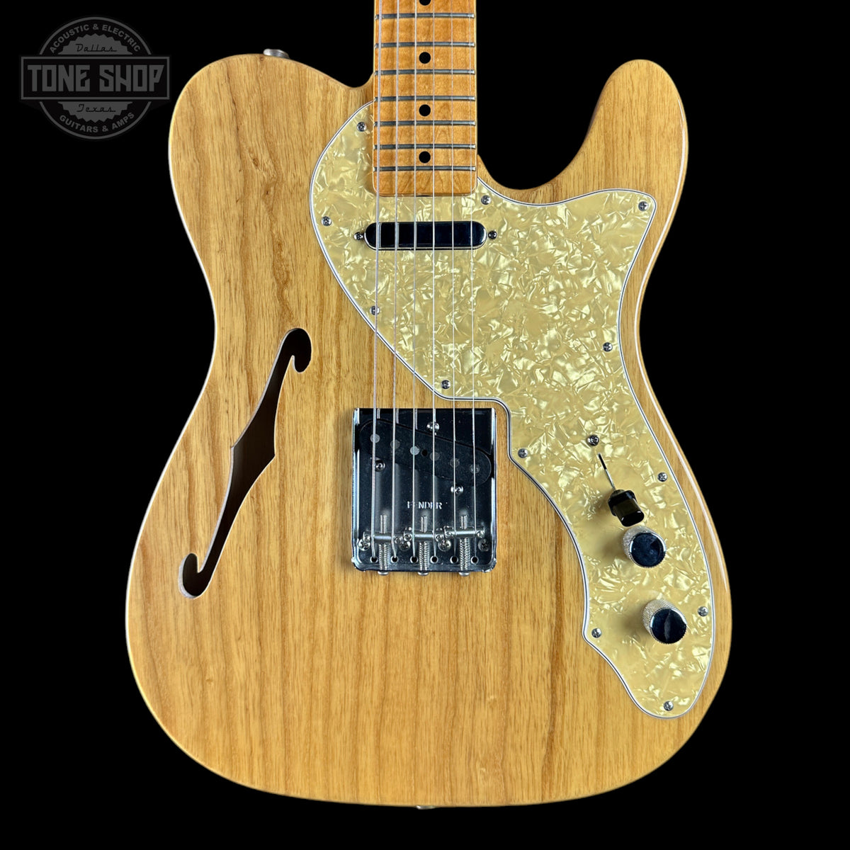 Wooden electric guitar with a visible brand logo in the corner