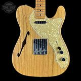 Wooden electric guitar with a visible brand logo in the corner
