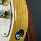 Close-up of a guitar's control knobs and wood finish