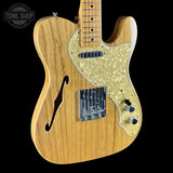 Wooden electric guitar with a visible brand logo in the corner